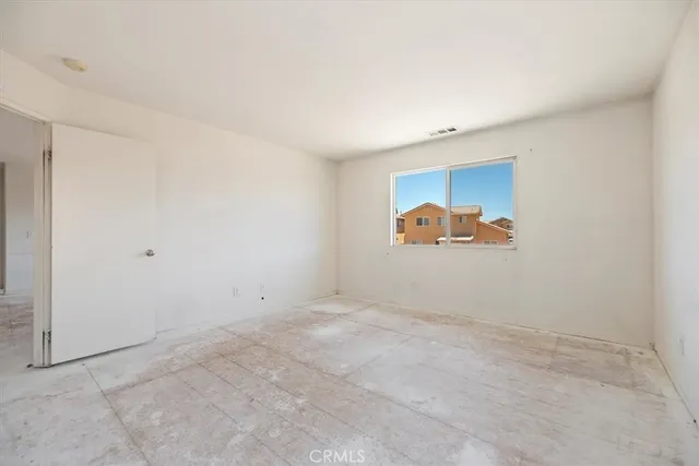 an empty room with wall painting and closet