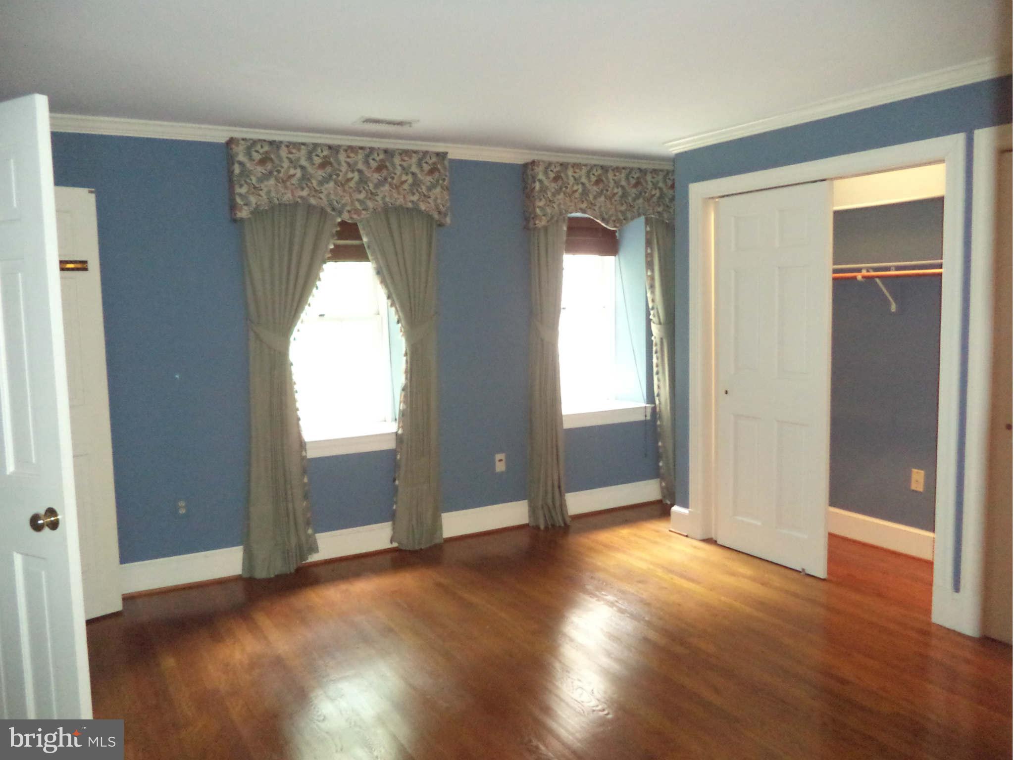 1304 Skipwith Road McLean, VA 22101 - Photo 19 of 25 an empty room with wooden floor and windows