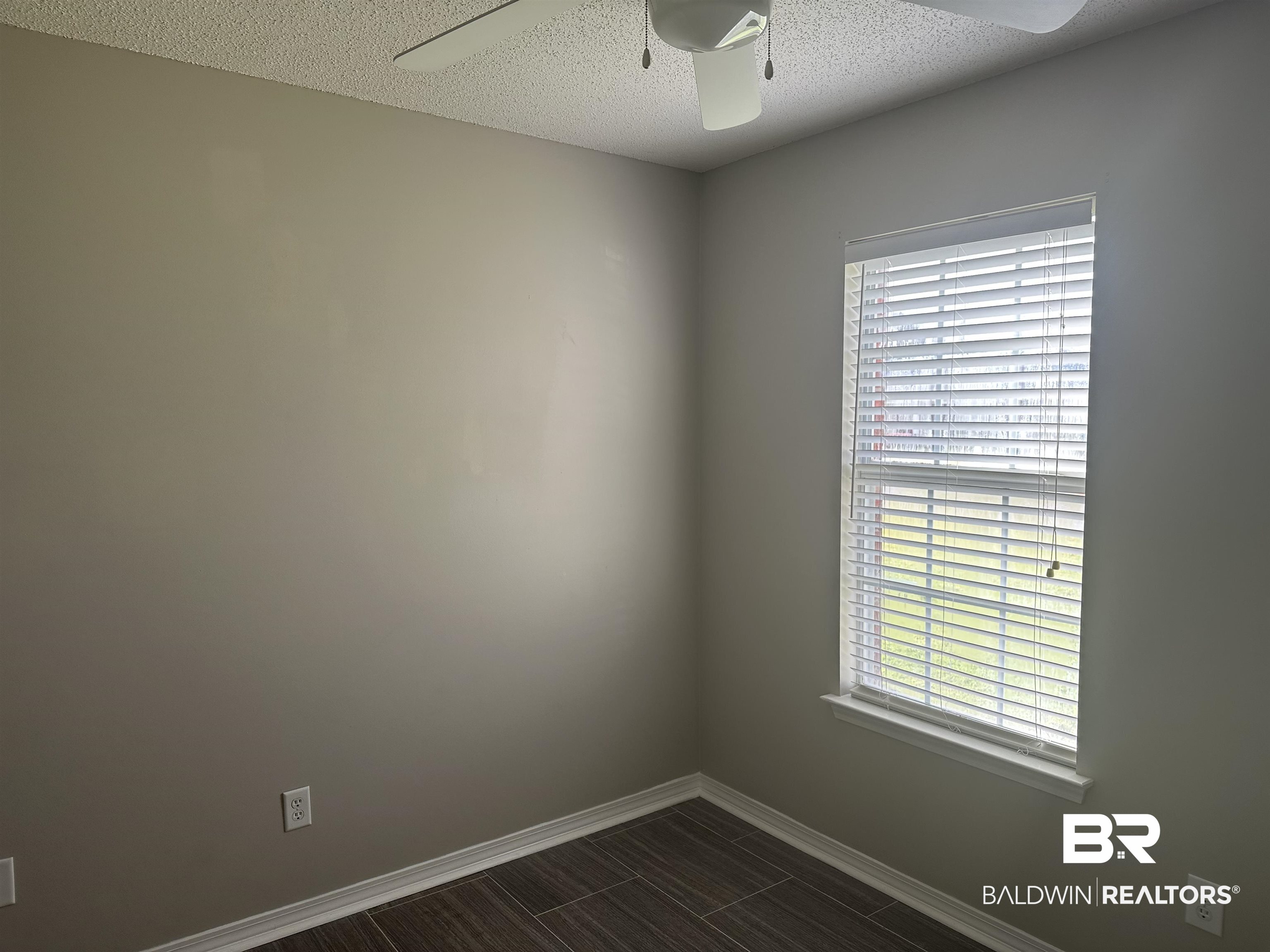 4882 Rebecca Place Mobile, AL 36695 - Photo 21 of 29 Spare room with baseboards, a textured ceiling, a healthy amount of sunlight, and a ceiling fan