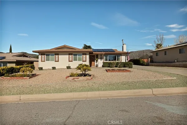 a view of multiple houses with a yard and sitting area
