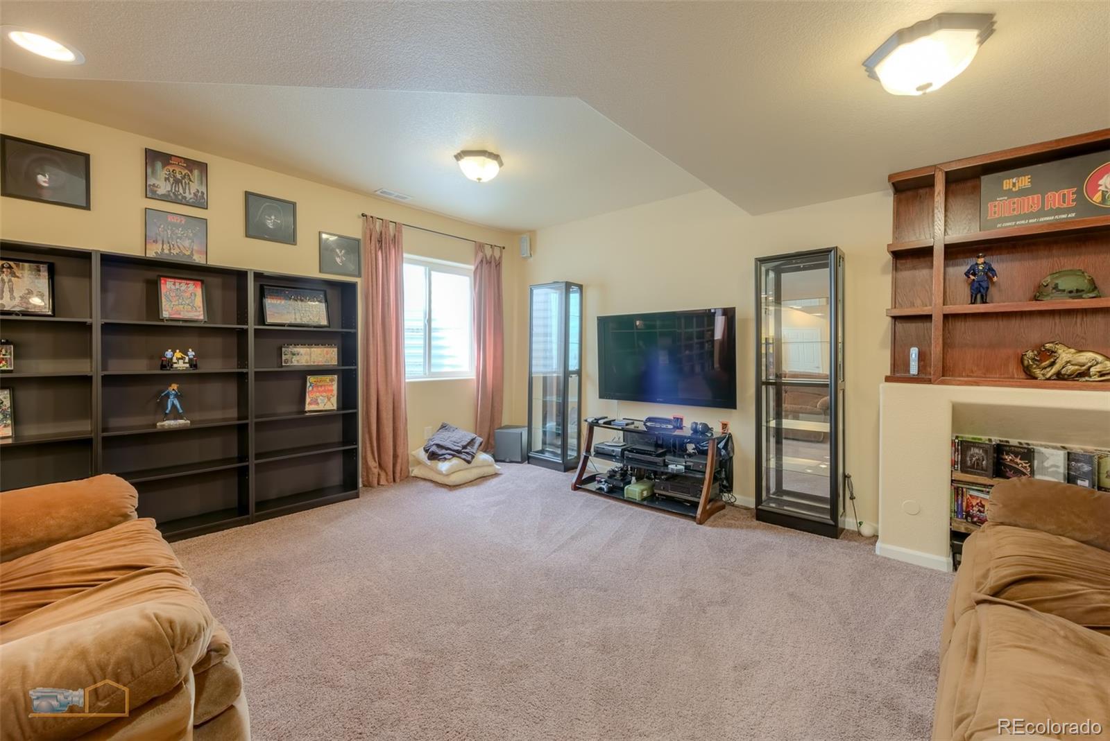 5513 Triple Crown Drive Frederick, CO 80504 - Photo 24 of 33 a living room with furniture and a flat screen tv