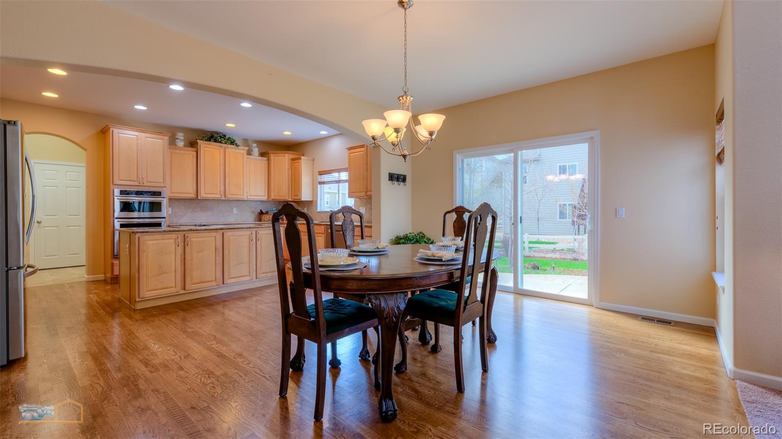 5513 Triple Crown Drive Frederick, CO 80504 - Photo 7 of 33 a view of a dining room with furniture and wooden floor