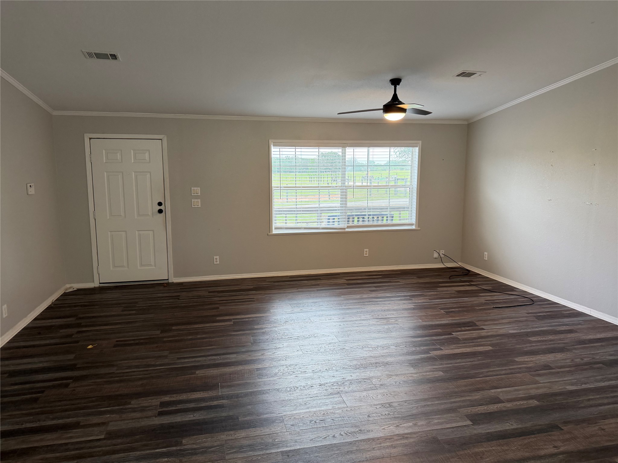 29480 Skymac Ranch Road Hempstead, TX 77445 - Photo 9 of 11 an empty room with wooden floor and windows