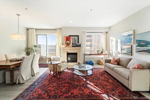a living room with furniture a fireplace and a table