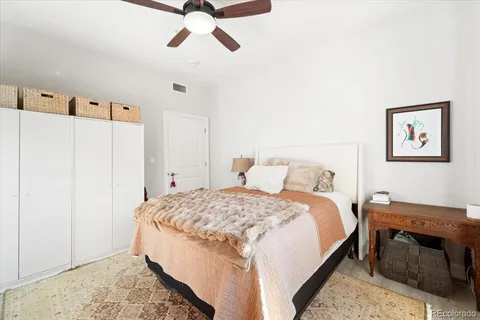 a bedroom with a bed and a painting on the wall