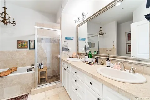 a bathroom with a double vanity sink a mirror and a bathtub