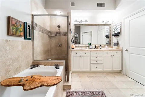 a bathroom with a bathtub and a sink mirror