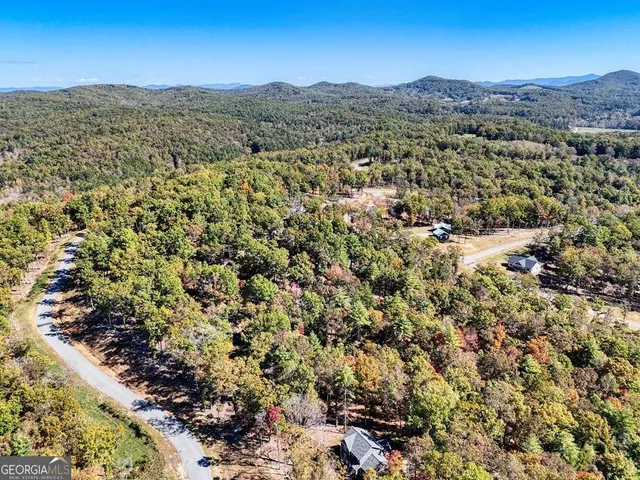 a view of a large mountain with a mountain in the background