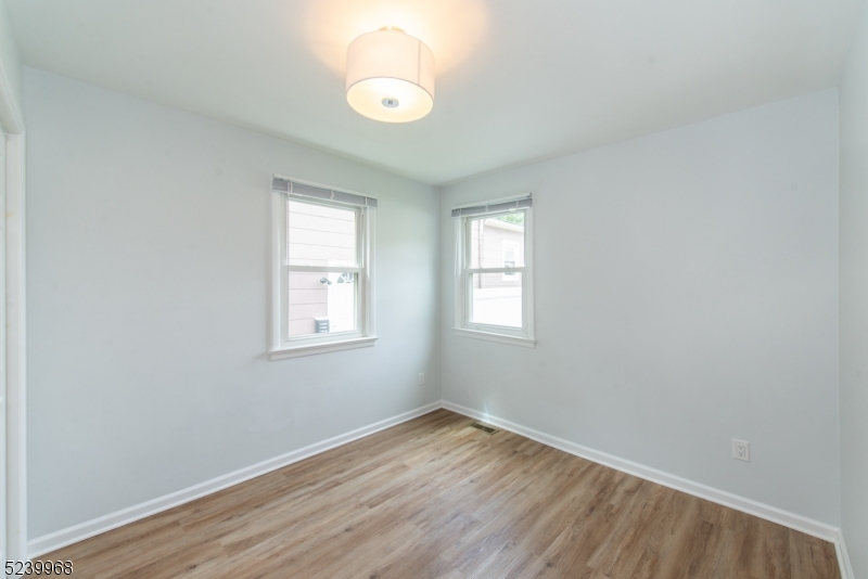 68 Orchard Street, Unit 1 Summit, NJ 07901 - Photo 12 of 23 an empty room with wooden floor and windows