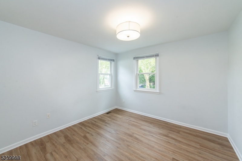 68 Orchard Street, Unit 1 Summit, NJ 07901 - Photo 13 of 23 an empty room with wooden floor and windows