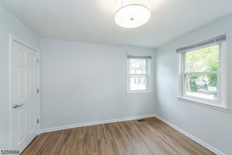 68 Orchard Street, Unit 1 Summit, NJ 07901 - Photo 14 of 23 an empty room with wooden floor and windows