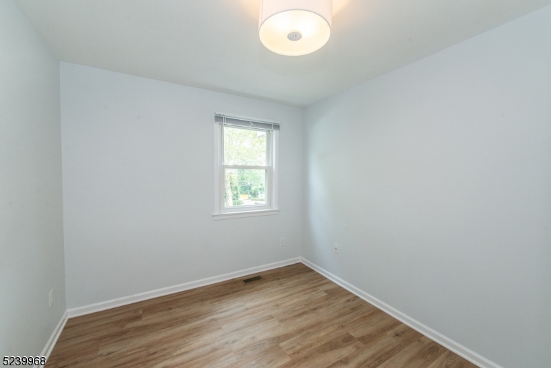 68 Orchard Street, Unit 1 Summit, NJ 07901 - Photo 15 of 23 an empty room with wooden floor and windows