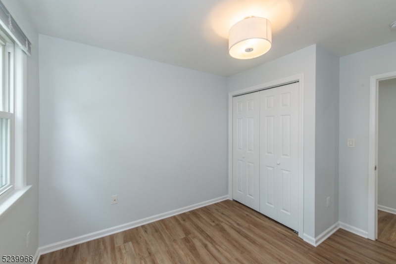 68 Orchard Street, Unit 1 Summit, NJ 07901 - Photo 16 of 23 a view of an empty room with wooden floor and a window