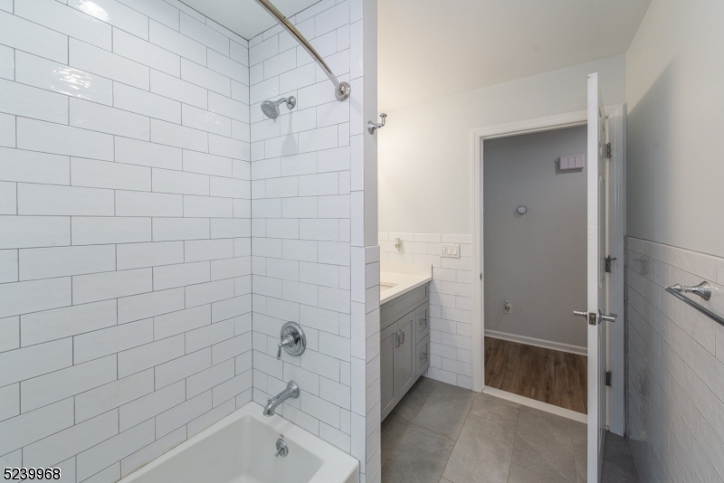 68 Orchard Street, Unit 1 Summit, NJ 07901 - Photo 18 of 23 a bathroom with a bathtub and a shower