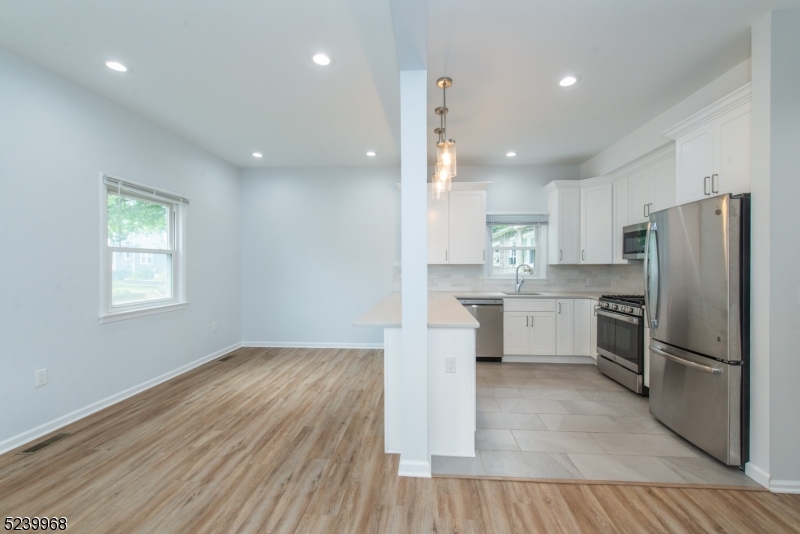 68 Orchard Street, Unit 1 Summit, NJ 07901 - Photo 4 of 23 a kitchen with a refrigerator and white cabinets