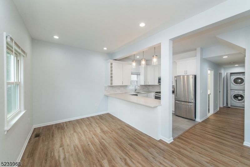 68 Orchard Street, Unit 1 Summit, NJ 07901 - Photo 5 of 23 a kitchen with stainless steel appliances kitchen island granite countertop a refrigerator and a stove top oven