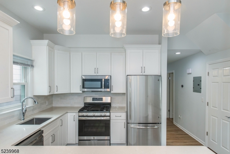 68 Orchard Street, Unit 1 Summit, NJ 07901 - Photo 7 of 23 a kitchen with a sink stainless steel appliances and cabinets
