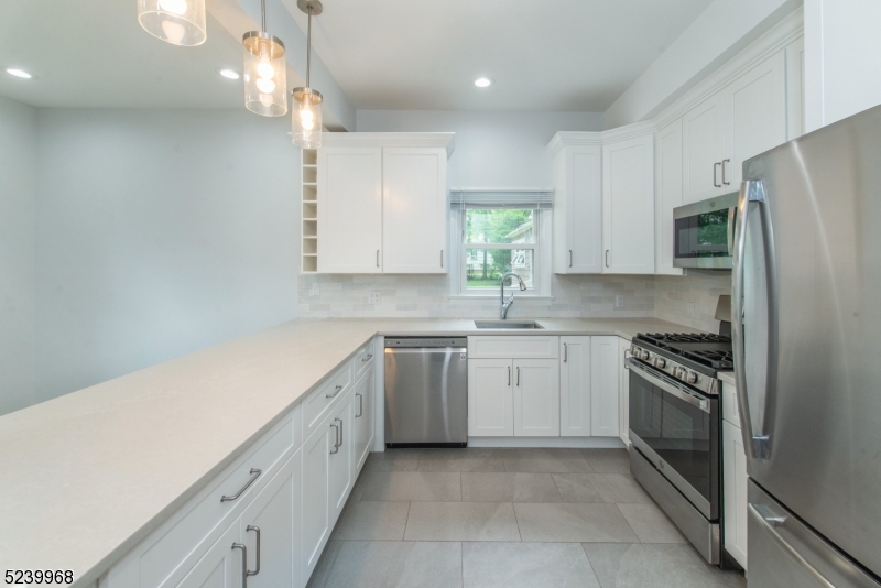 68 Orchard Street, Unit 1 Summit, NJ 07901 - Photo 8 of 23 a kitchen with a white cabinets and refrigerator