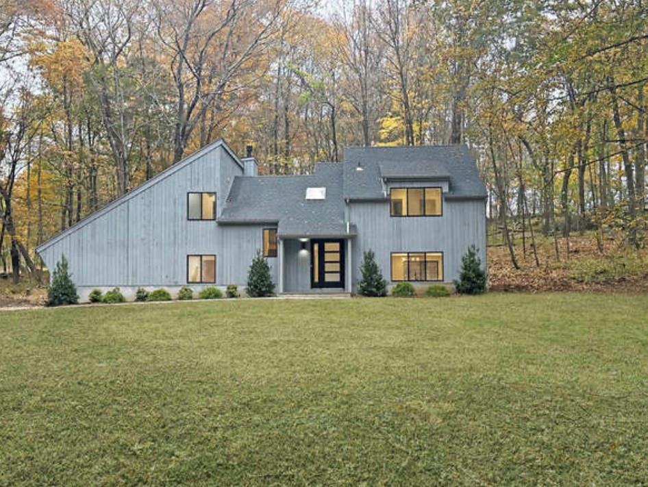 a front view of a house with a yard