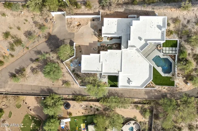 an aerial view of residential houses with outdoor space