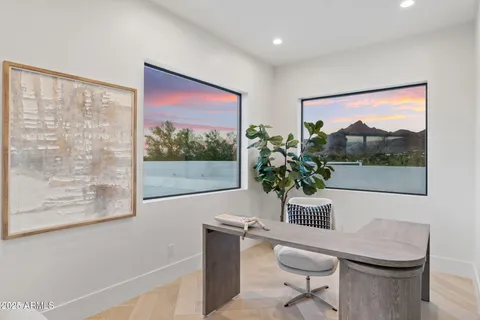 a large bedroom with a large bed and glass door