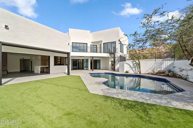 a view of house with swimming pool outdoor seating