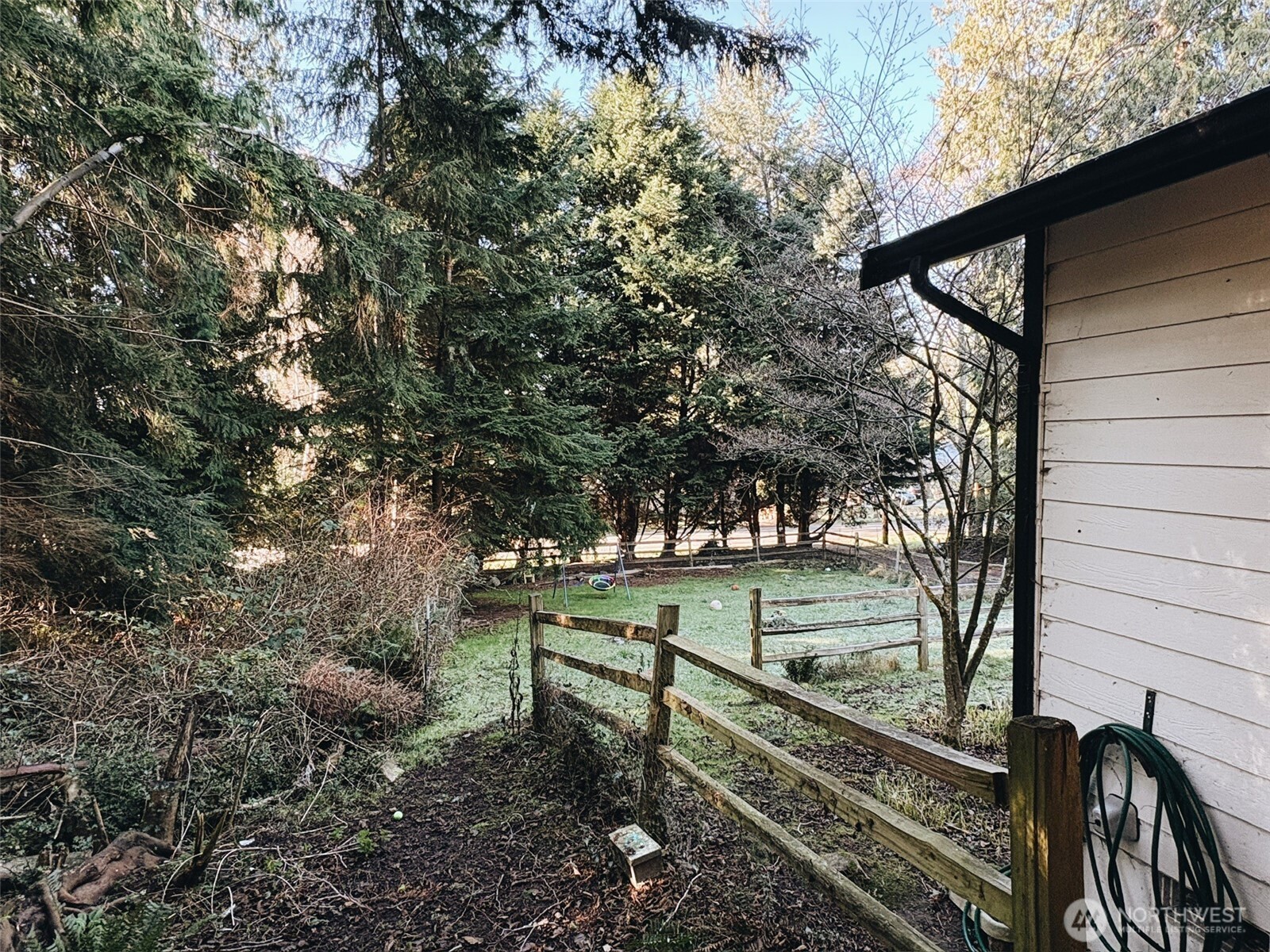 3257 East Harbor Road Langley, WA 98260 - Photo 18 of 20 a view of a bench in the backyard of a house