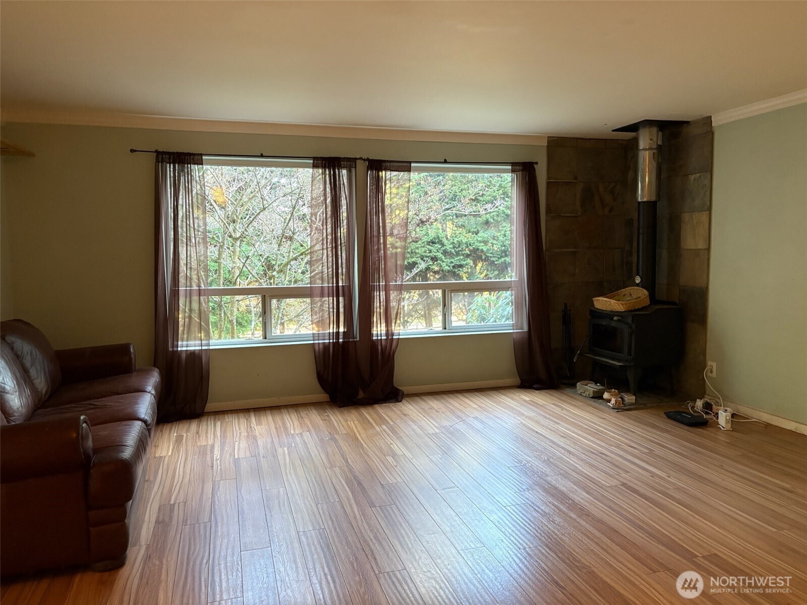 3257 East Harbor Road Langley, WA 98260 - Photo 3 of 20 a view of an empty room with a window and wooden floor