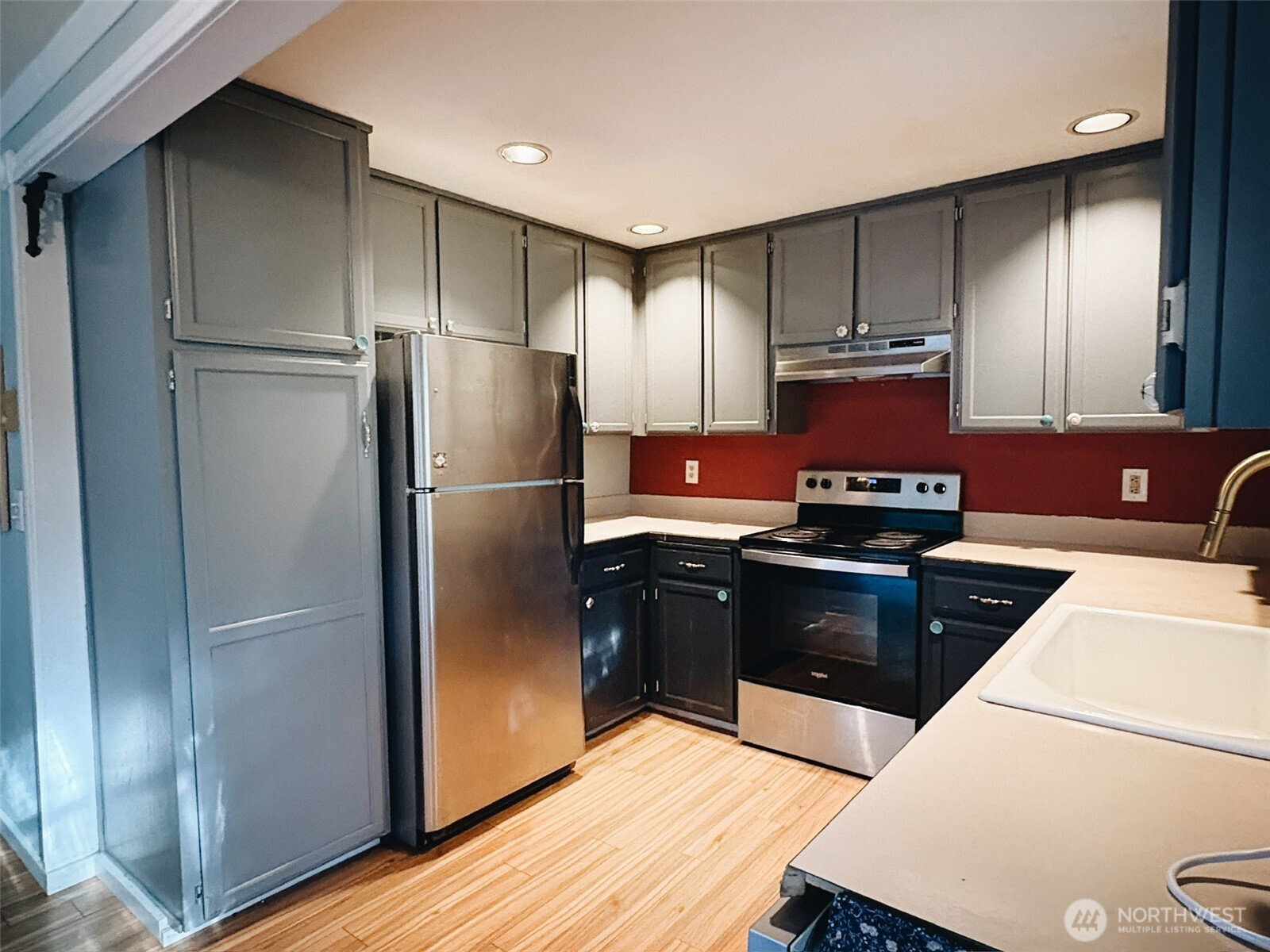 3257 East Harbor Road Langley, WA 98260 - Photo 5 of 20 a kitchen with a refrigerator stove and wooden cabinets