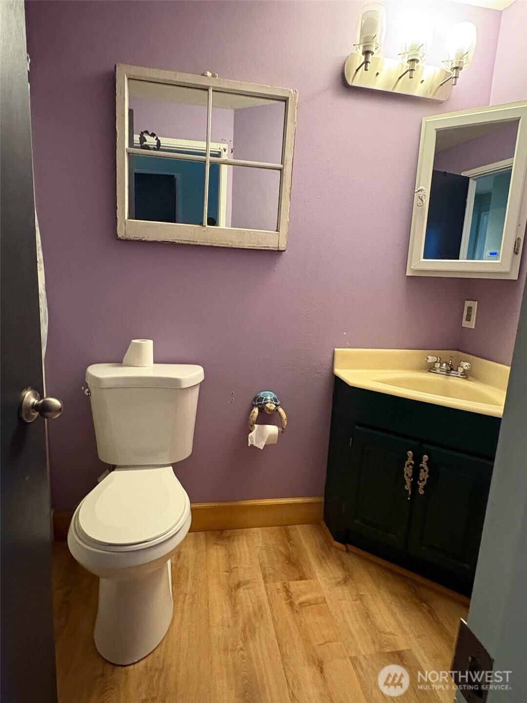 3257 East Harbor Road Langley, WA 98260 - Photo 8 of 20 a bathroom with a toilet sink and mirror