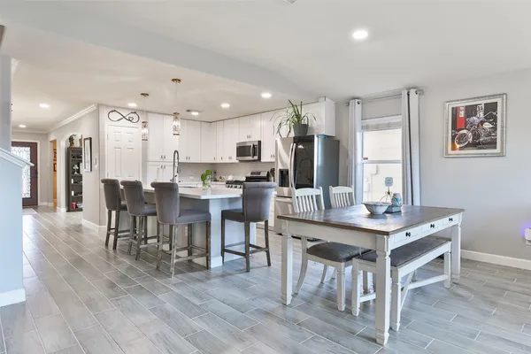 a kitchen with stainless steel appliances granite countertop a stove a microwave and cabinets