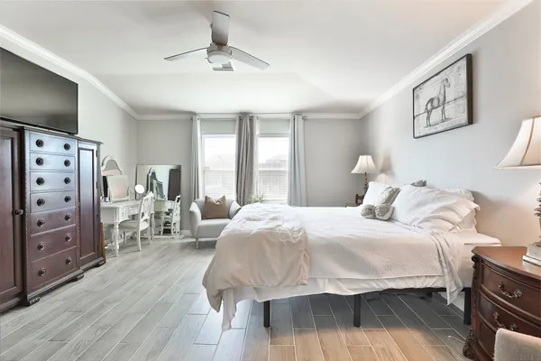 a bedroom with a bed couch and window