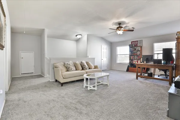 a living room with furniture a bookshelf and a bookshelf