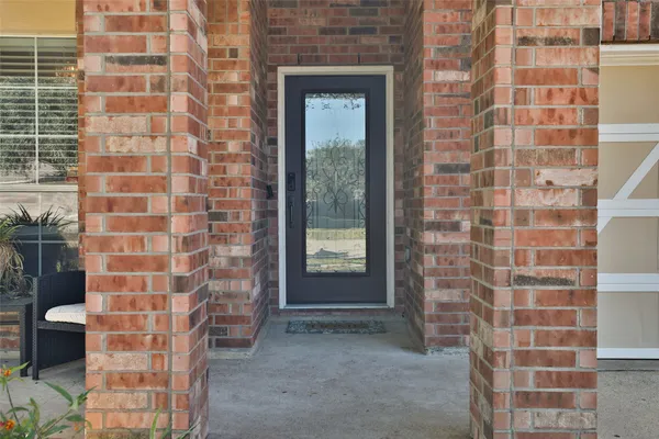 a view of hallway with wooden floor and stairs