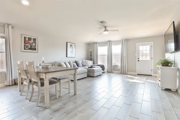 a large kitchen with a sink and refrigerator