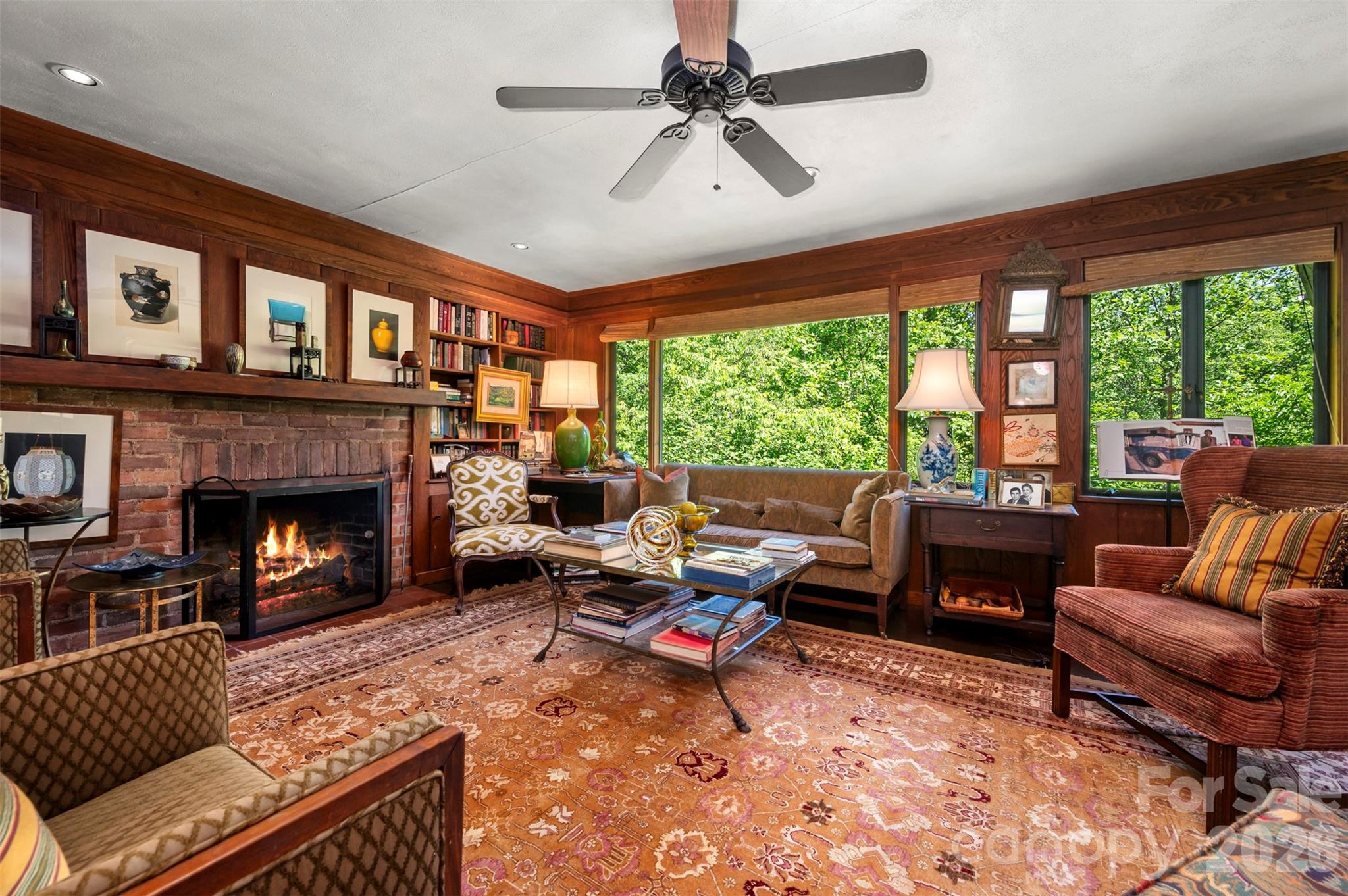 484 Sourwood Ridge Road Tryon, NC 28782 - Photo 11 of 34 a living room with furniture a fireplace and a large window