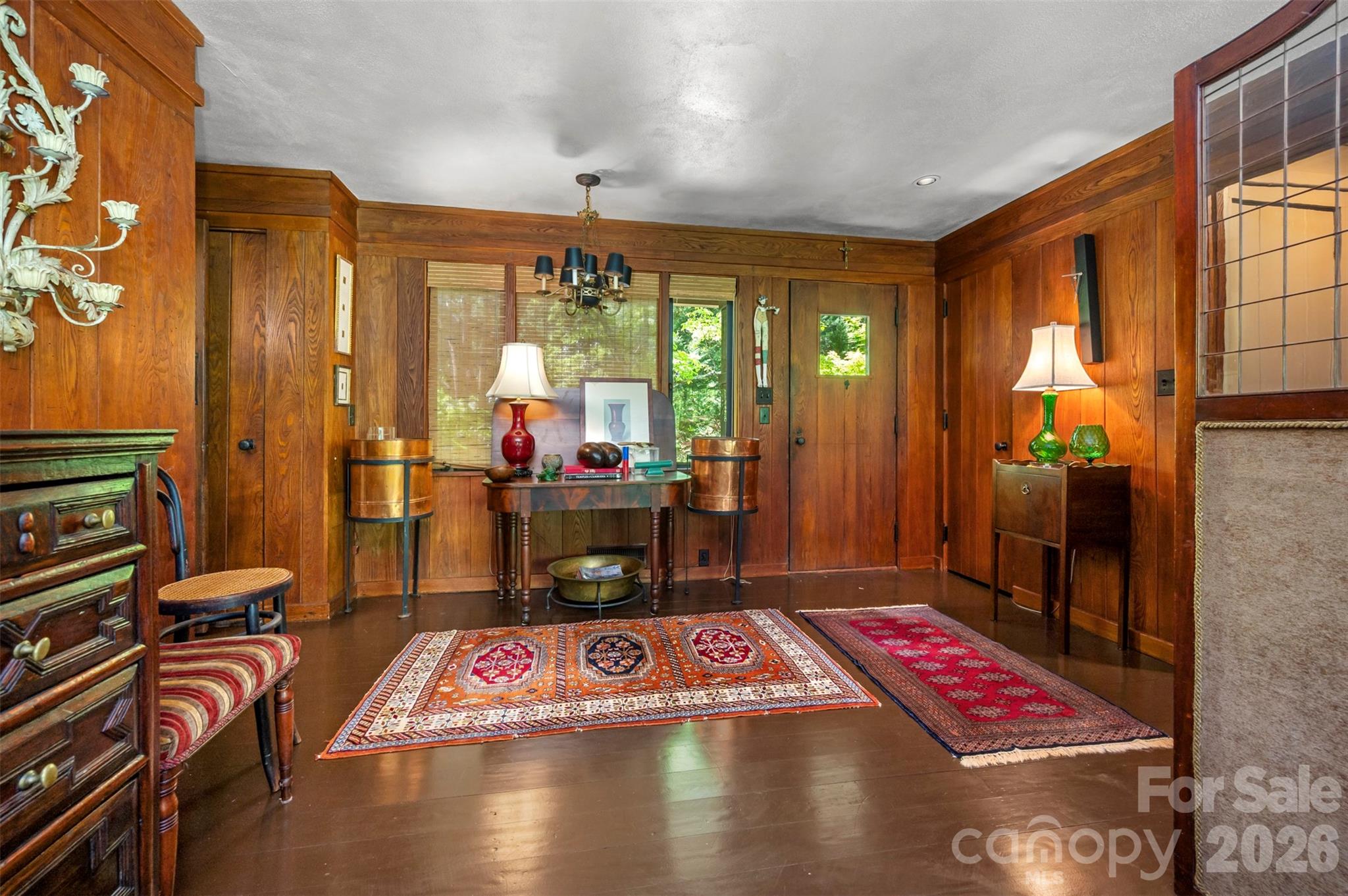 484 Sourwood Ridge Road Tryon, NC 28782 - Photo 13 of 34 a living room with furniture a rug and a chandelier