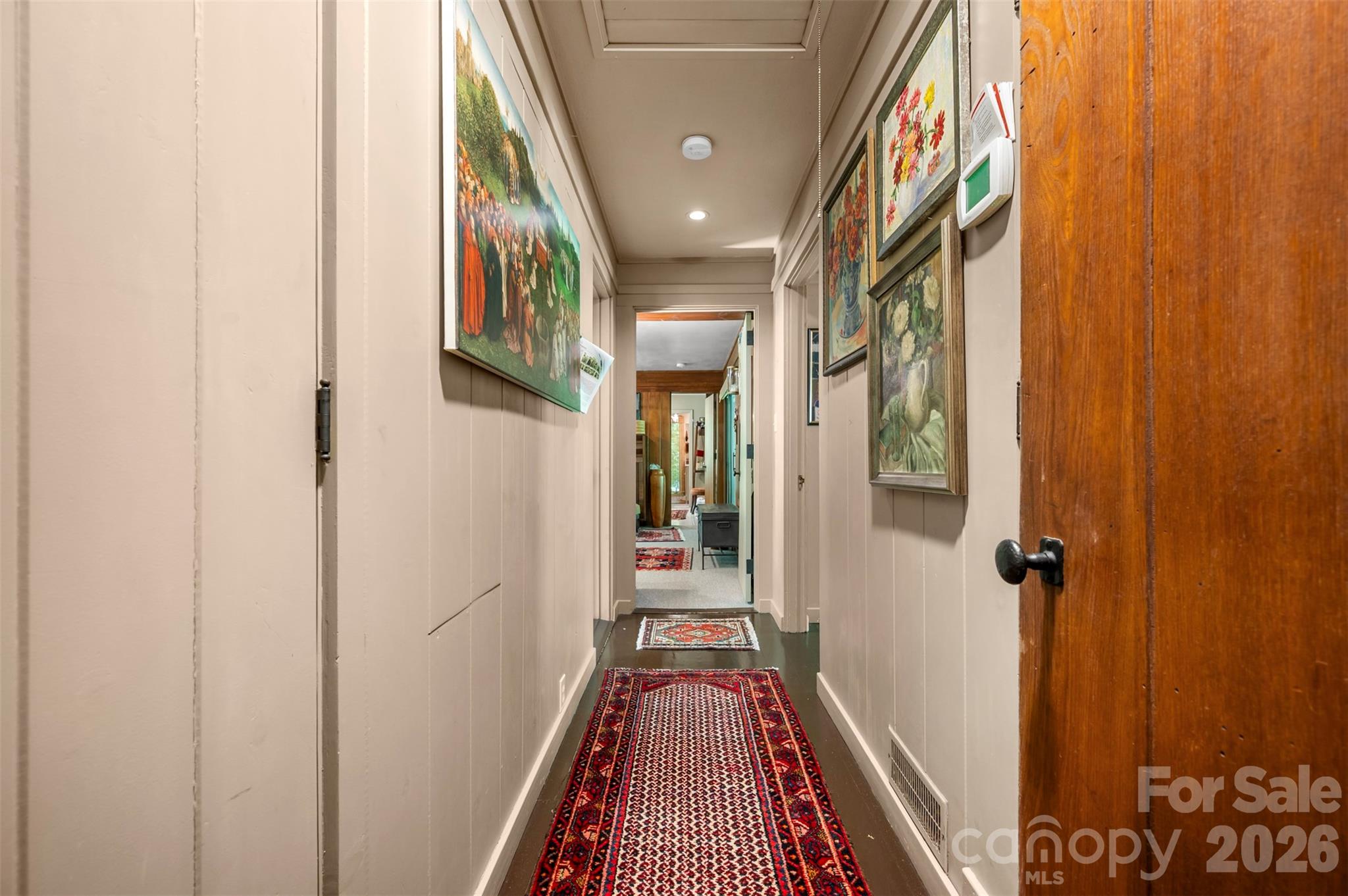 484 Sourwood Ridge Road Tryon, NC 28782 - Photo 14 of 34 a view of a hallway with wooden floor and stairs
