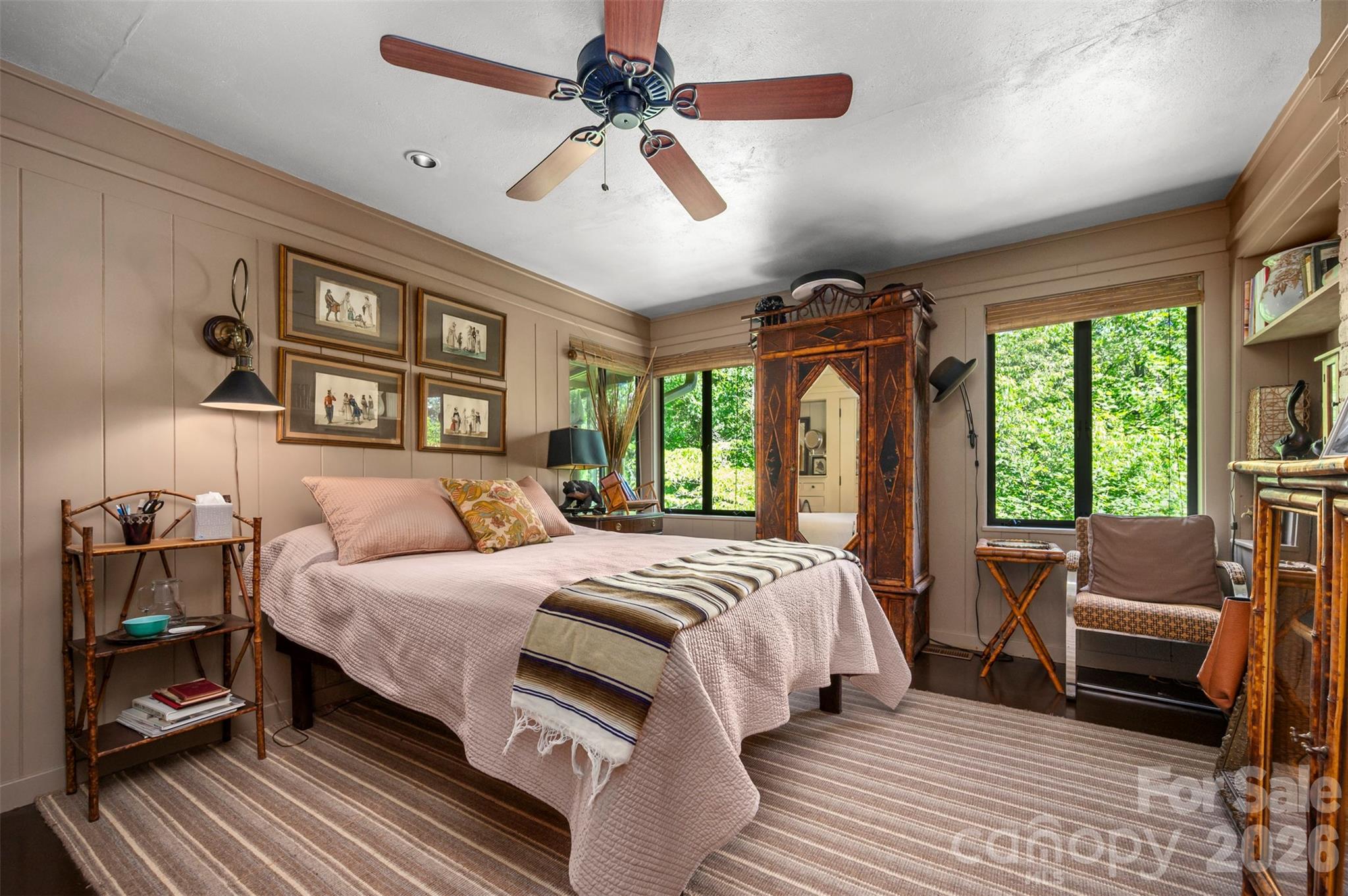 484 Sourwood Ridge Road Tryon, NC 28782 - Photo 15 of 34 a bedroom with a large bed and a chandelier