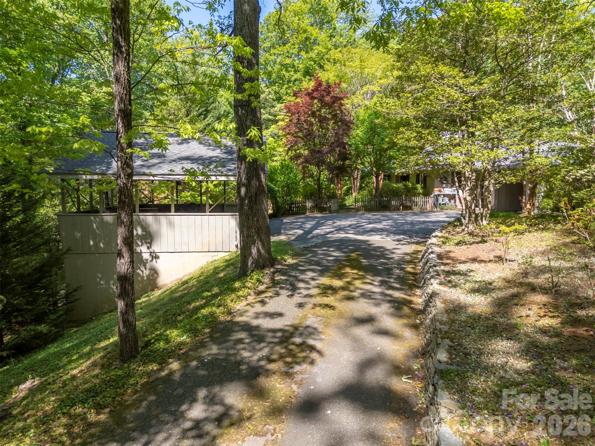 484 Sourwood Ridge Road Tryon, NC 28782 - Photo 27 of 34 a view of a yard with plants and trees