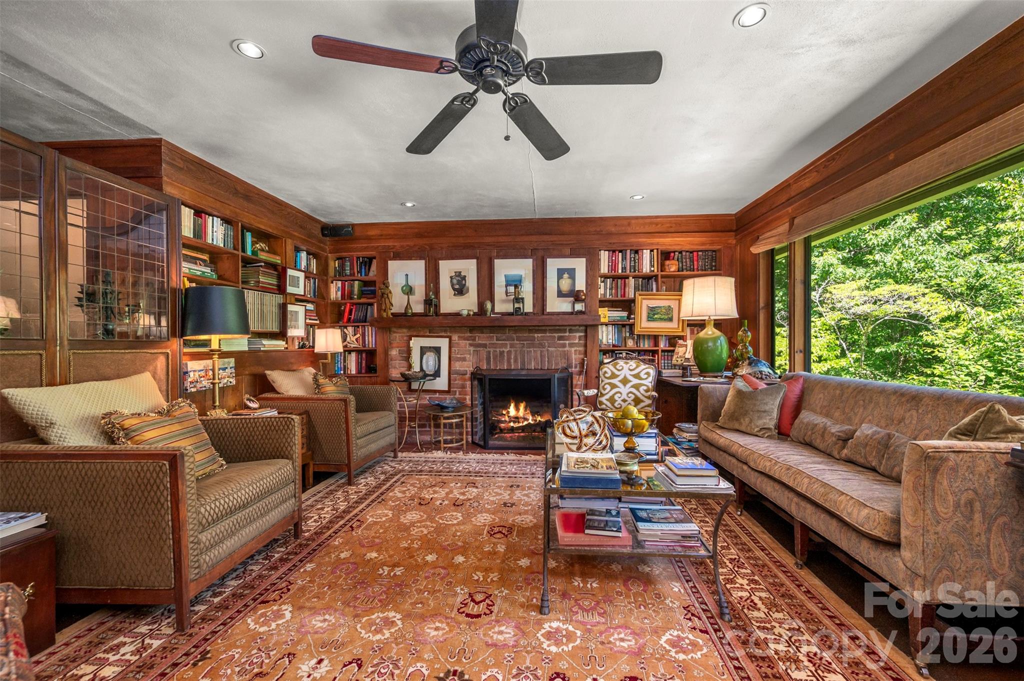 484 Sourwood Ridge Road Tryon, NC 28782 - Photo 10 of 34 a living room with furniture a fireplace and a large window