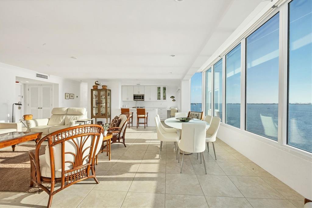 350 Golden Gate Point, Unit 62 Sarasota, FL 34236 - Photo 11 of 40 a dining room with furniture and large windows