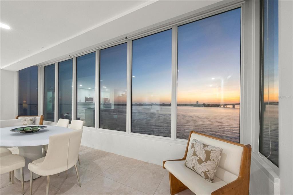 350 Golden Gate Point, Unit 62 Sarasota, FL 34236 - Photo 14 of 40 a dining room with furniture and wooden floor