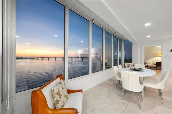 a outdoor space with the floor to ceiling windows and kitchen view