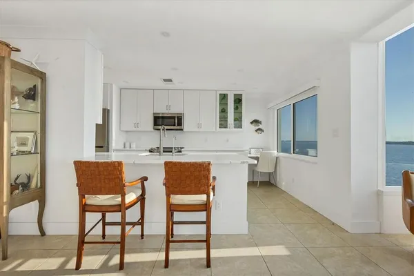a living room with furniture a fireplace and a view of kitchen