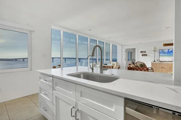 a kitchen with sink and natural light