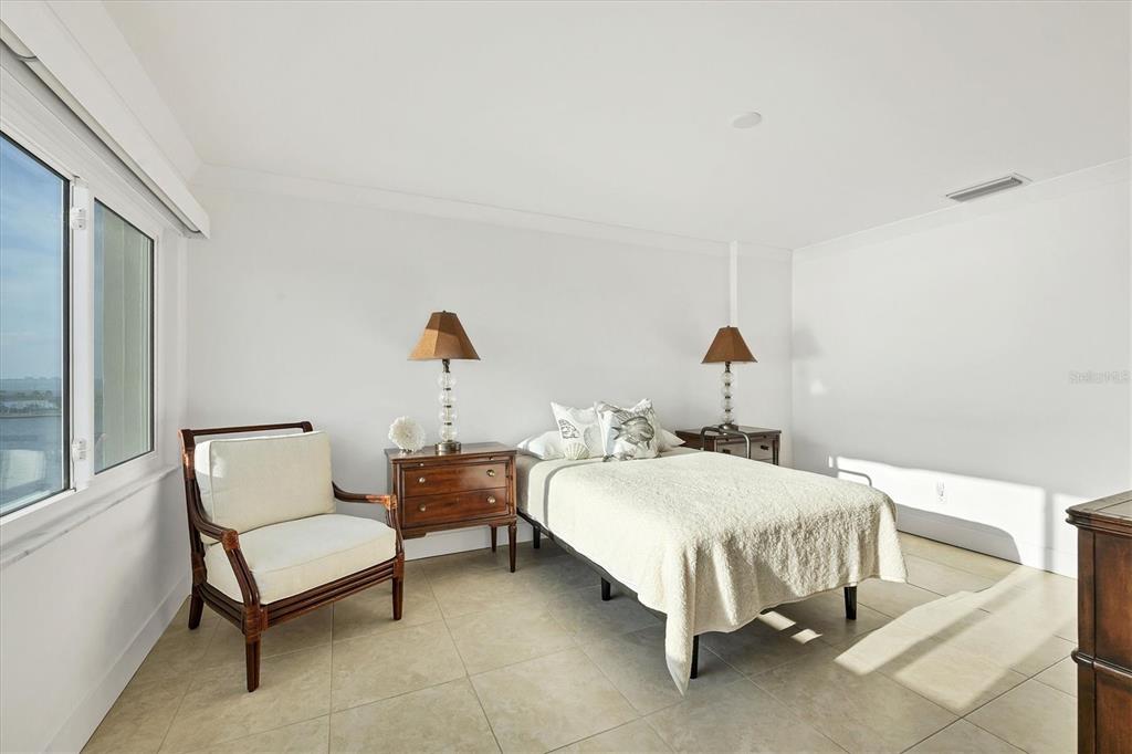 350 Golden Gate Point, Unit 62 Sarasota, FL 34236 - Photo 22 of 40 a bedroom with a bed and a window