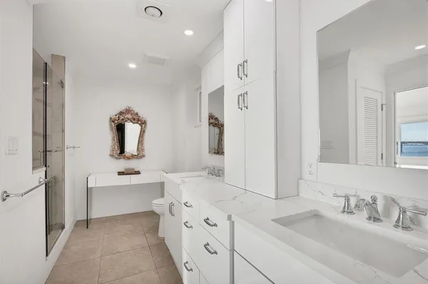 a spacious bathroom with a double vanity sink mirror and double