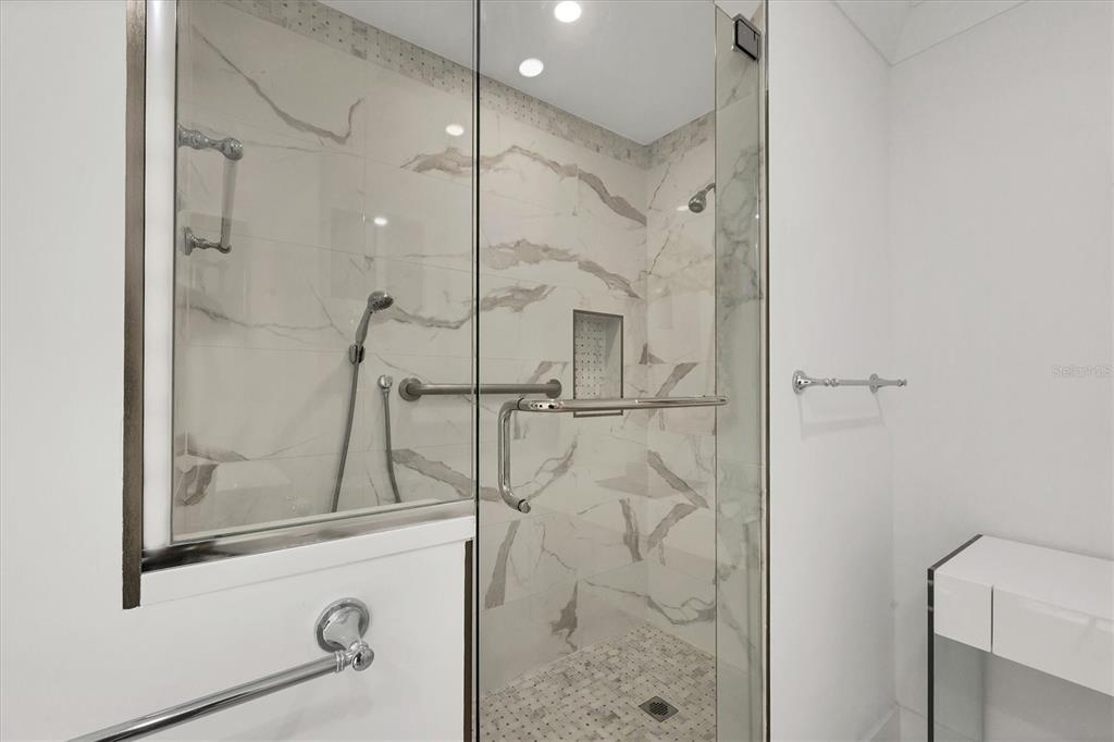 350 Golden Gate Point, Unit 62 Sarasota, FL 34236 - Photo 26 of 40 a bathroom with a glass shower door