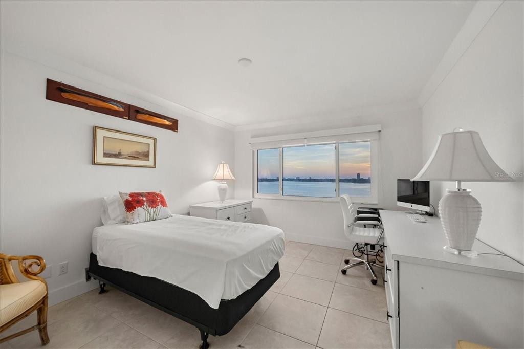 350 Golden Gate Point, Unit 62 Sarasota, FL 34236 - Photo 27 of 40 a bedroom with a bed and wooden floor